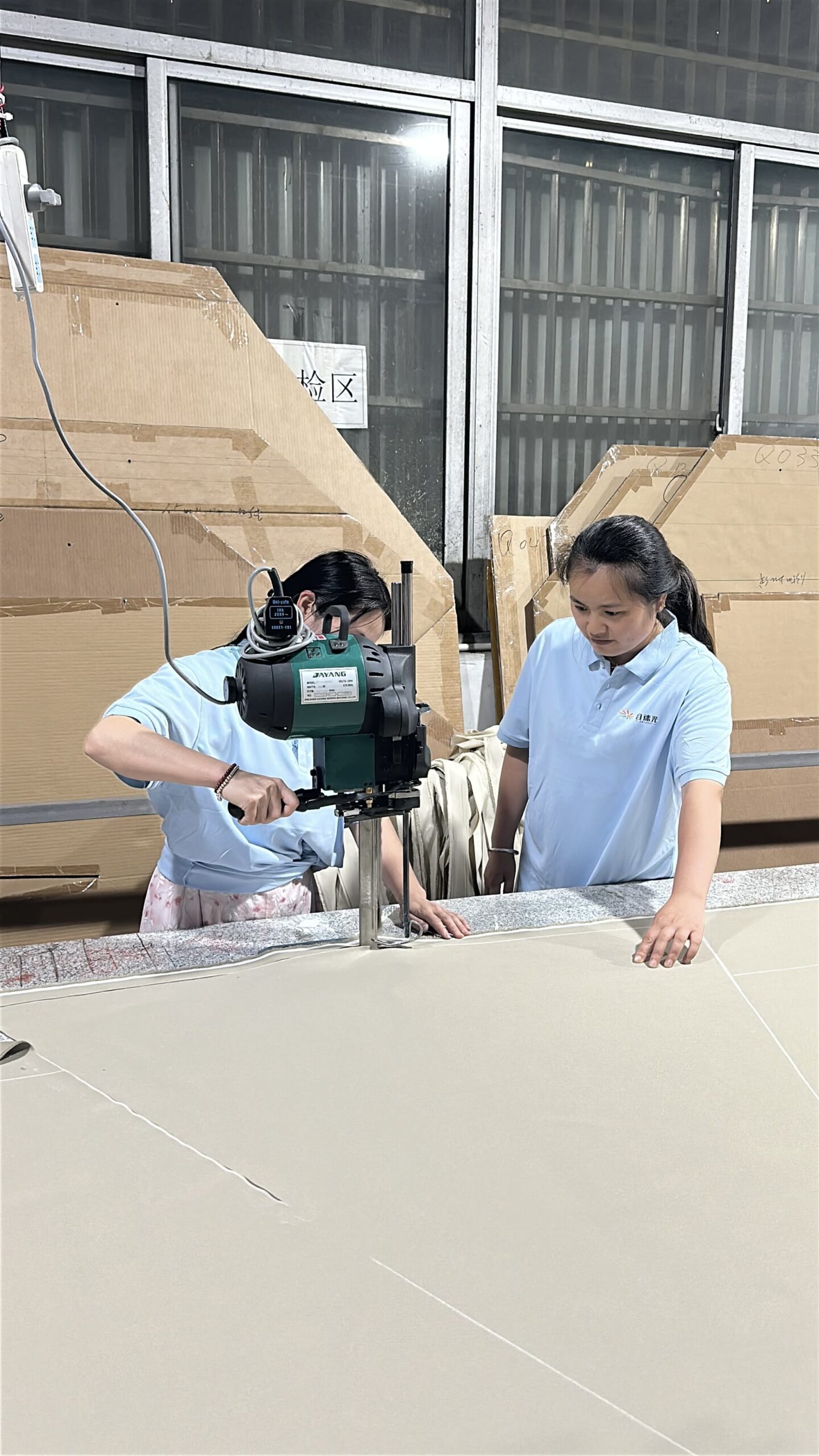 Workers cutting and preparing umbrella canopy fabric