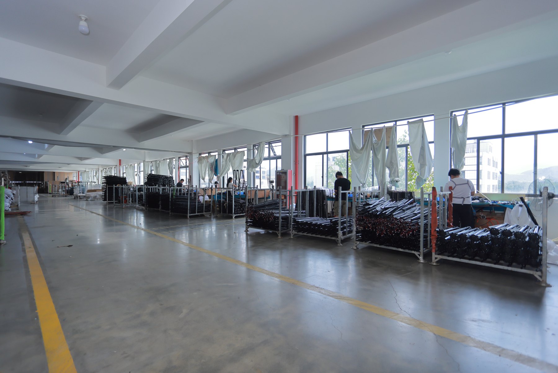 Solargy production floor with organized commercial umbrella frames ready for assembly