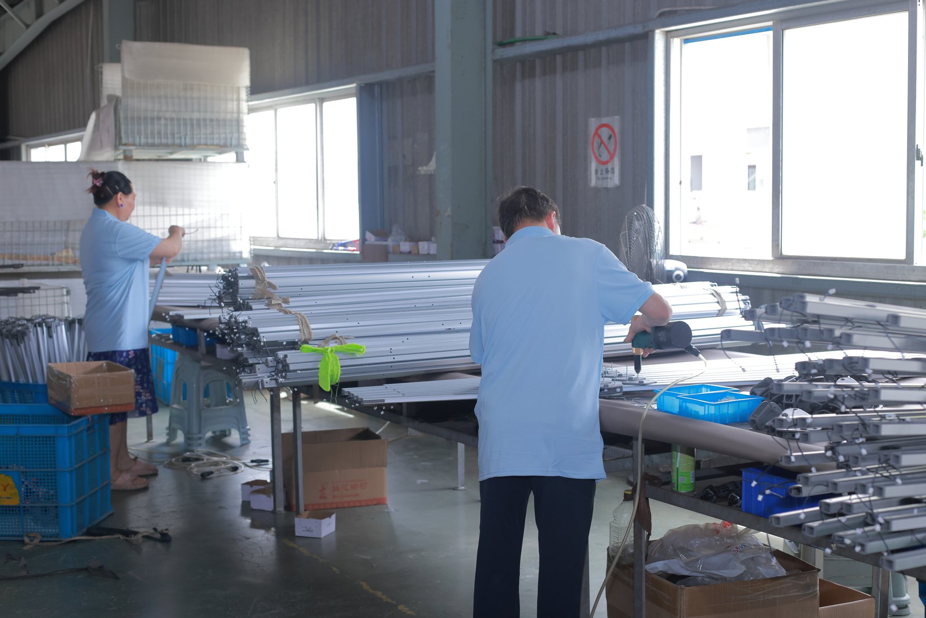 Solargy technicians assembling commercial solar umbrella frames on the production line