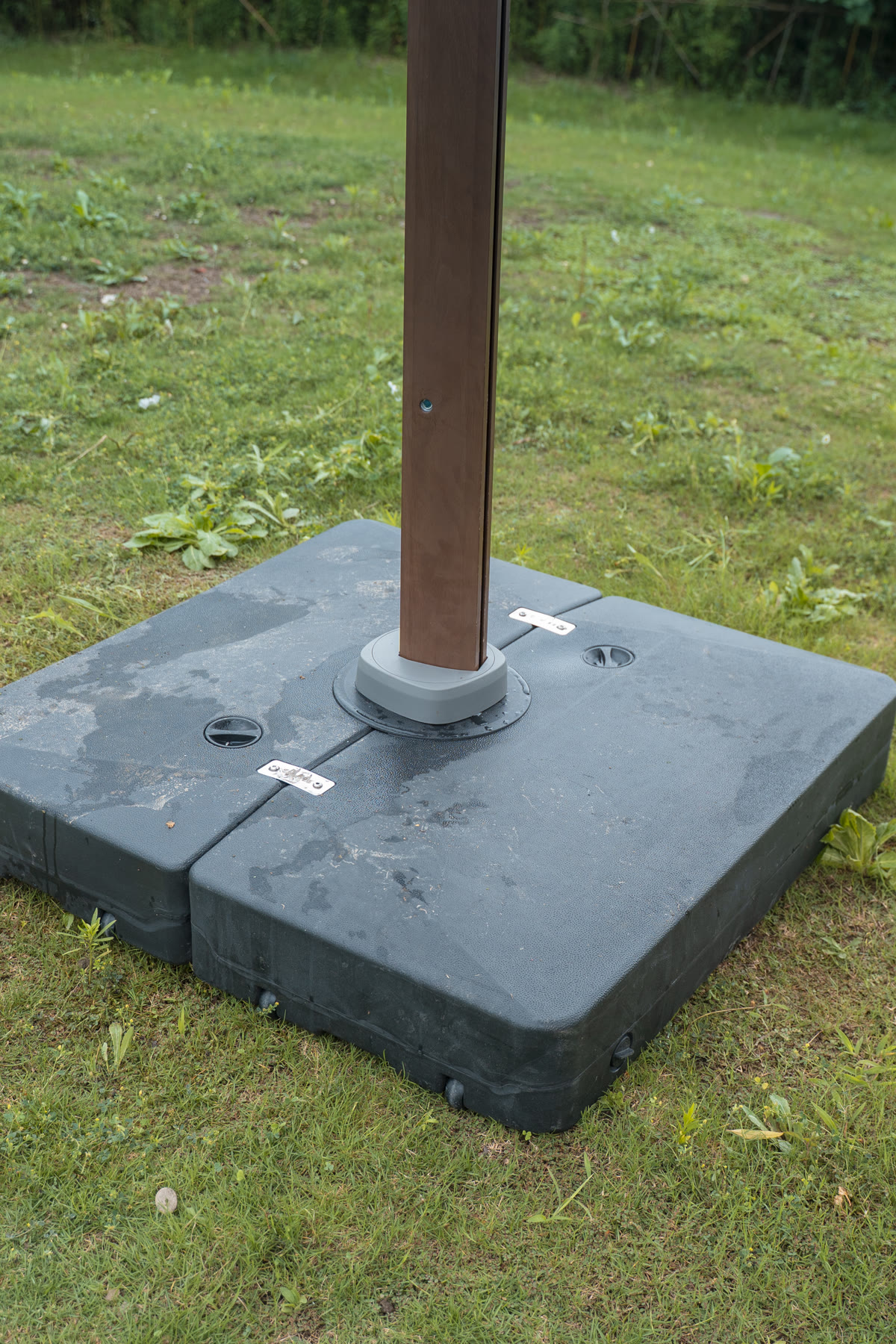 Close view of the two-part water-fillable umbrella base and recessed filling ports